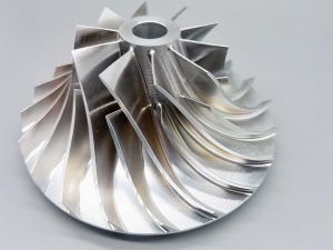 Close-up view of a complex aluminum turbine component after intricate CNC machining by HS Molds.